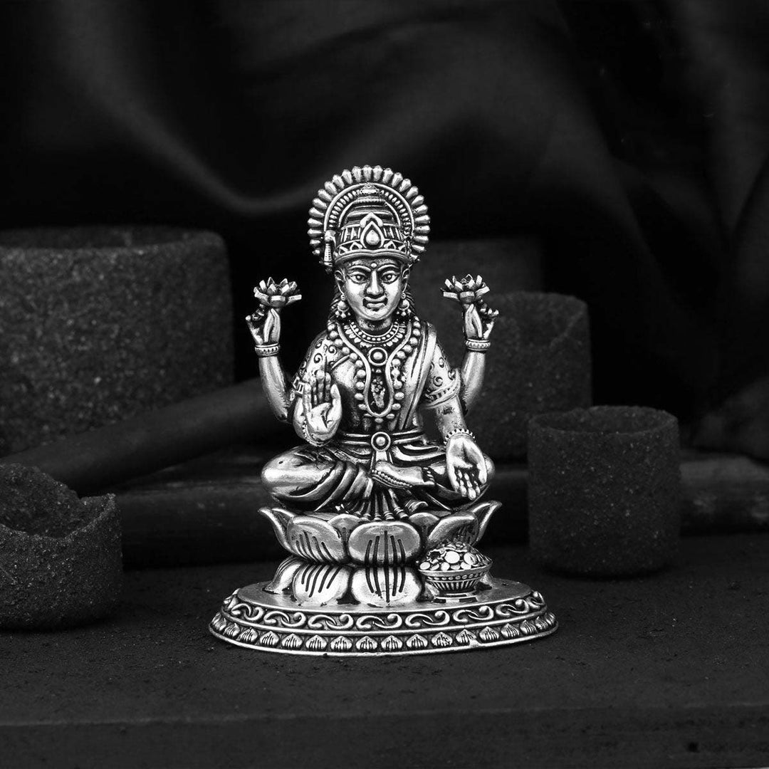 Bring home the Goddess of Wealth. This silver Lakshmi idol, seated gracefully on a lotus, is designed to radiate peace and prosperity throughout your home.